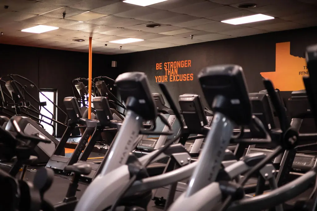 Cardio zone with Matrix treadmills and motivational wall art at TX Fitness Forney